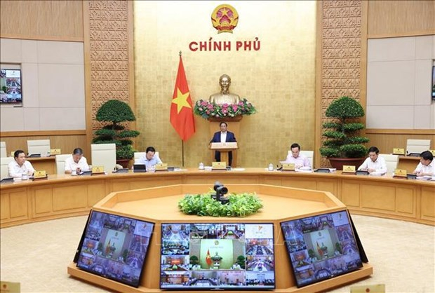 PM Pham Minh Chinh (centre) chairs the Government&rsquo;s regular meeting and a teleconference with the 63 provinces and centrally-run cities on April 3. (Photo: VNA)