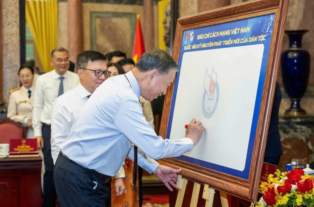 Tổng Bí thư, Chủ tịch nước Tô Lâm ký lưu niệm vào biểu trưng của Hội Nhà báo Việt Nam. Ảnh: Báo SGGP
