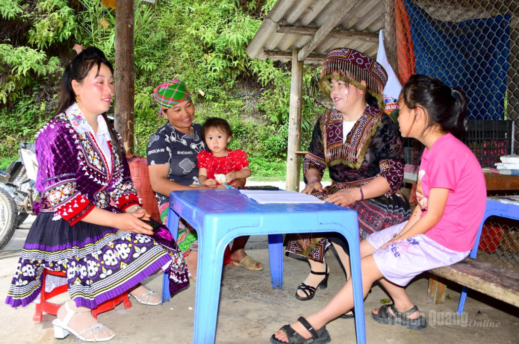 Đồng chí Mua Thị Sình (ngồi thứ 2 từ phải qua trái), Bí thư Chi bộ thôn Bản Phùng tuyên truyền người dân giữ gìn bản sắc văn hóa.
