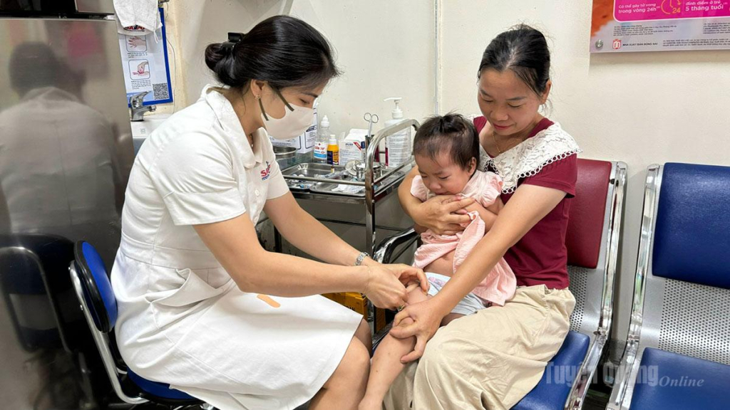 Người dân đưa trẻ đến tiêm chủng tại phòng tiêm chủng, Trung tâm Kiểm soát bệnh tật tỉnh.