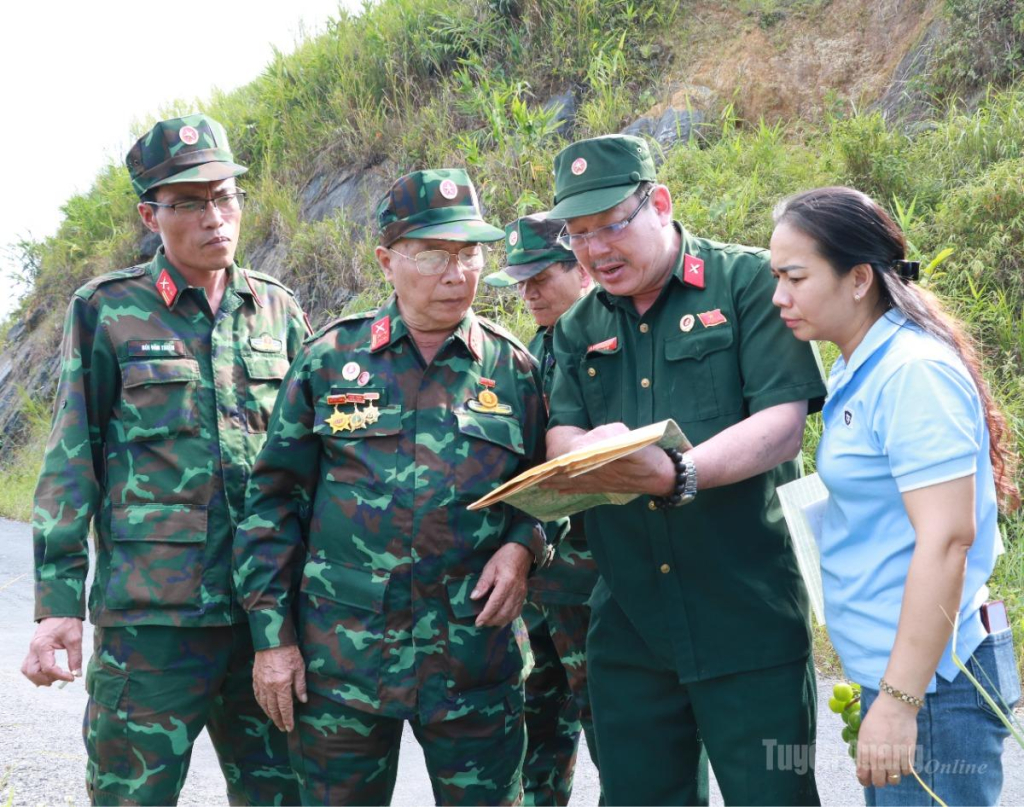 Các cựu chiến binh đối chiếu bản đồ với địa hình thực tế để xác định vị trí tìm kiếm hài cốt liệt sĩ.